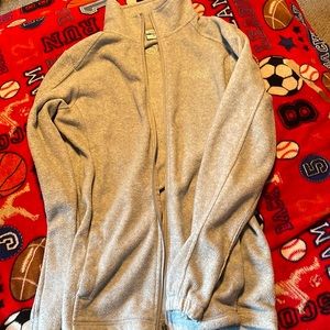 This is a lightly loved zip-up jacket that is grey it is “Magellan outdoors”